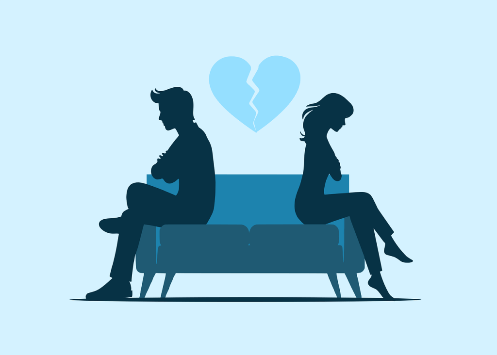 Silhouettes of a man and woman sitting apart on a couch, both appearing sad, with a broken heart graphic above them.