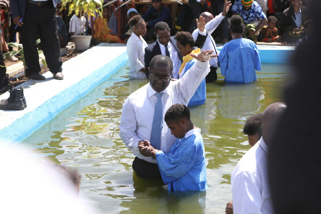 Pastor Miller Kuso, Director, Sabbath School and Personal Ministries, Papua New Guinea Union Mission, baptising. Baptism in Minj, Jiwaka Province, Papua New Guinea, in May 2024.