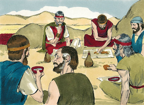 A group of men seated in a desert setting, sharing a meal, with food and drink visible, illustrating a communal moment.