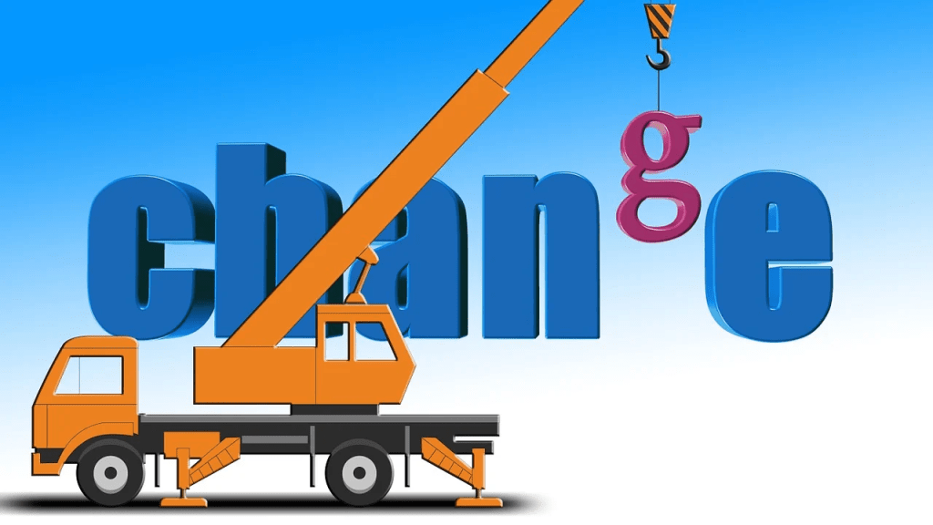An illustration featuring a construction crane lifting the letter 'g' in 'change,' with the letters 'c,' 'h,' 'a,' and 'n' in blue against a light blue background.