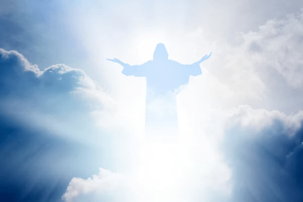 A figure in a robe with outstretched arms appears amidst bright clouds and beams of light.