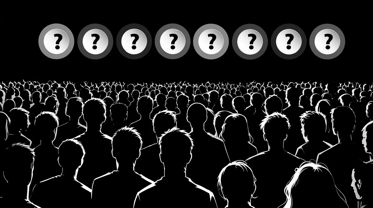 Conceptual crowd mystery and unknown identities Silhouetted crowd facing eight large question marks in circles against a black background