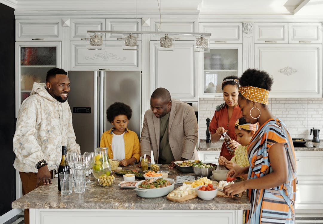 Family preparing and enjoying a meal together in a modern kitchen