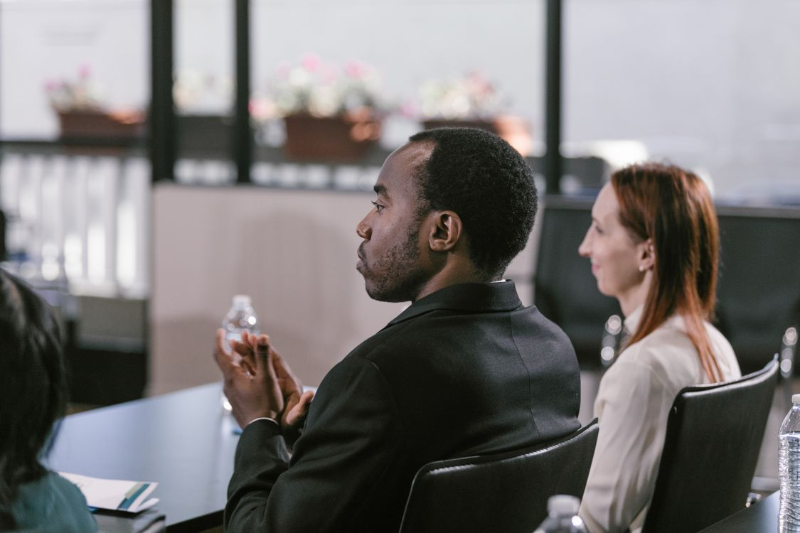 People sitting and listening attentively in a meeting room