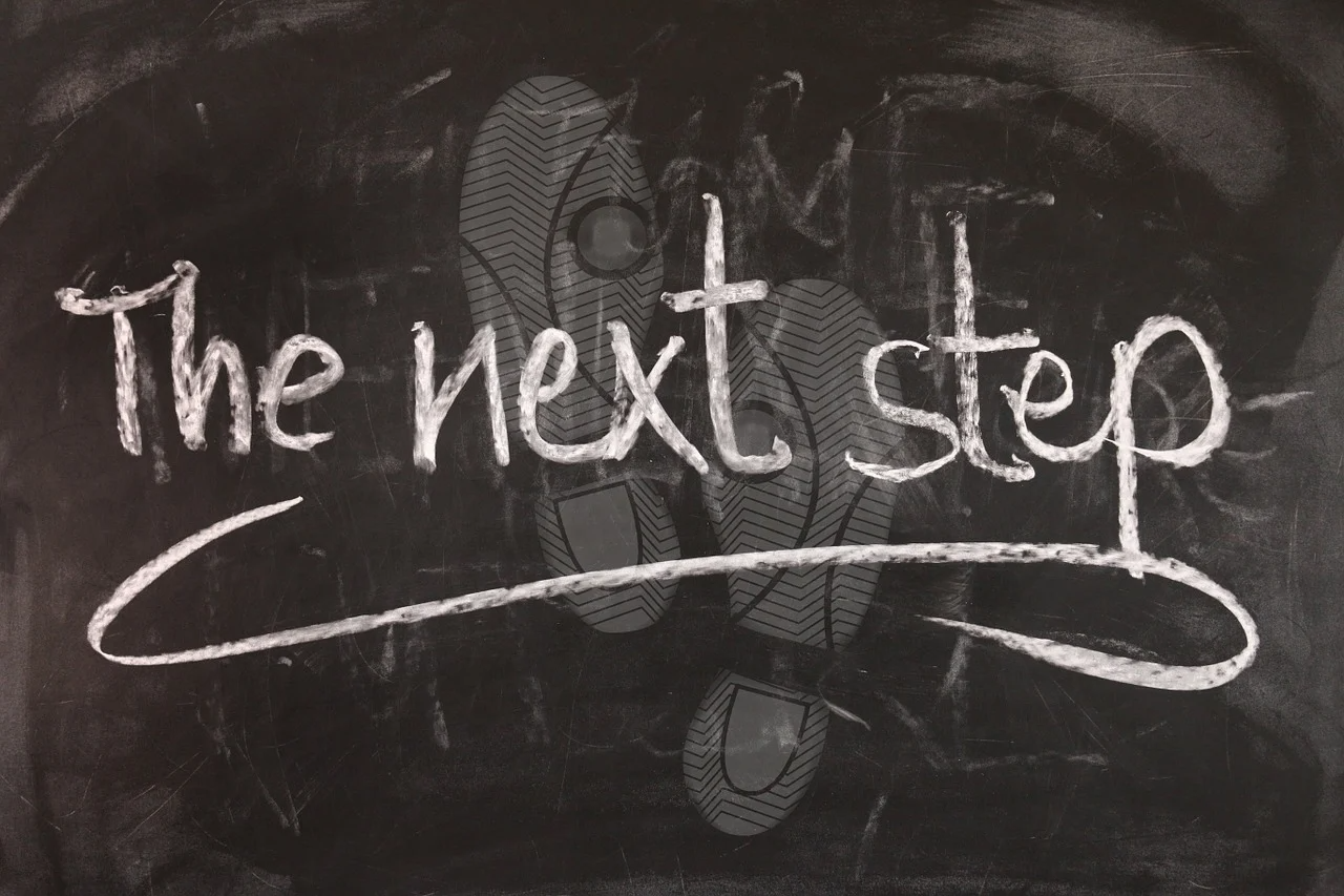 Chalkboard illustration explaining the next step Chalkboard reading “The next step” overlaid on footprints